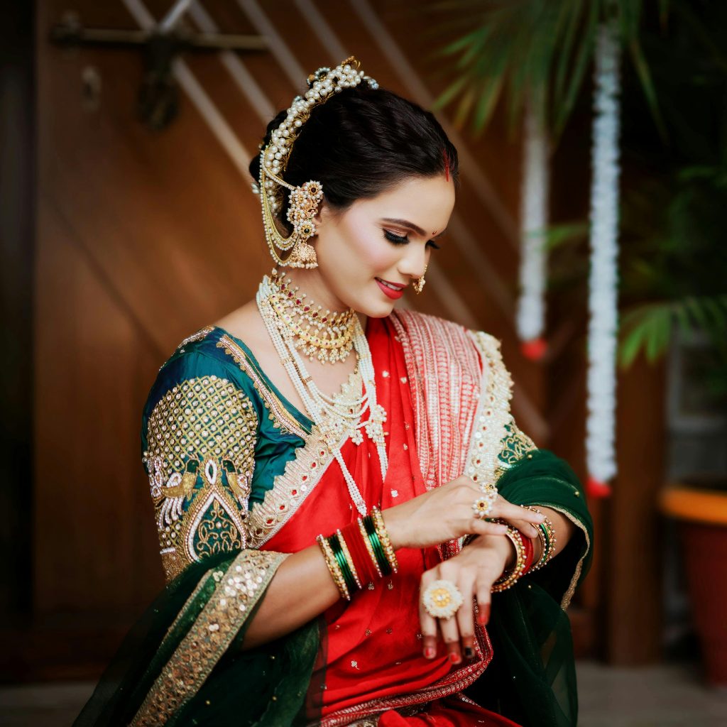 A beautiful Indian bride in traditional attire, showcasing intricate jewelry and saree.